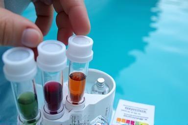 Technician using a water testing kit to analyze pool water quality